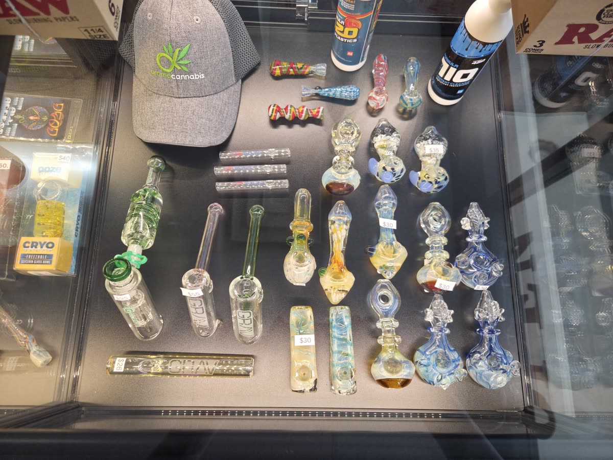 Glass pipes and an Aroma Cannabis hat in the case